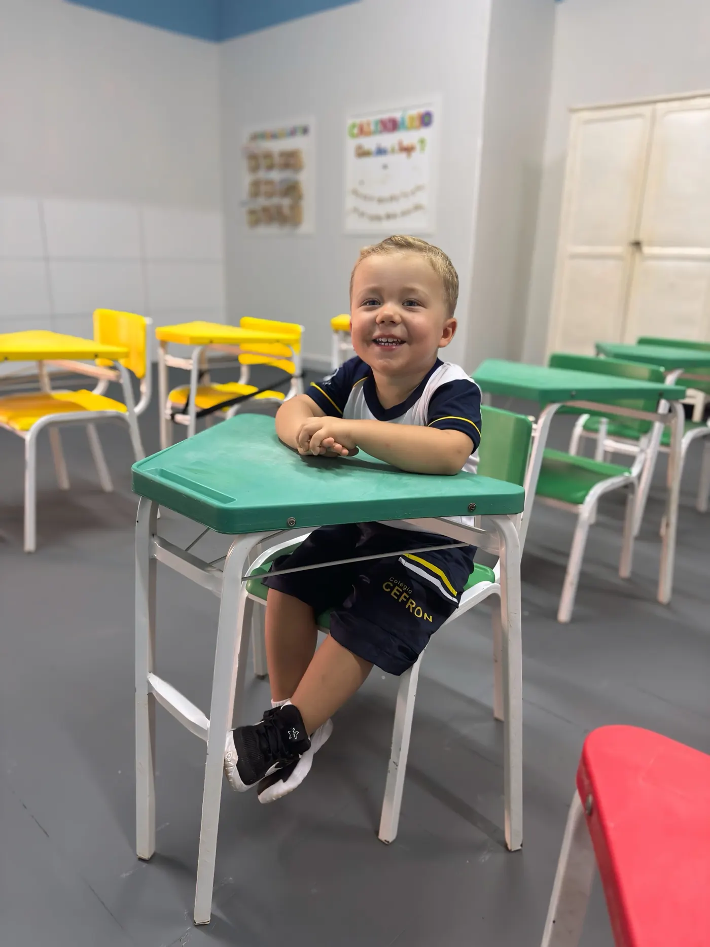 Criança sorrindo na sala de aula da Educação Infantil do Colégio Cefron
